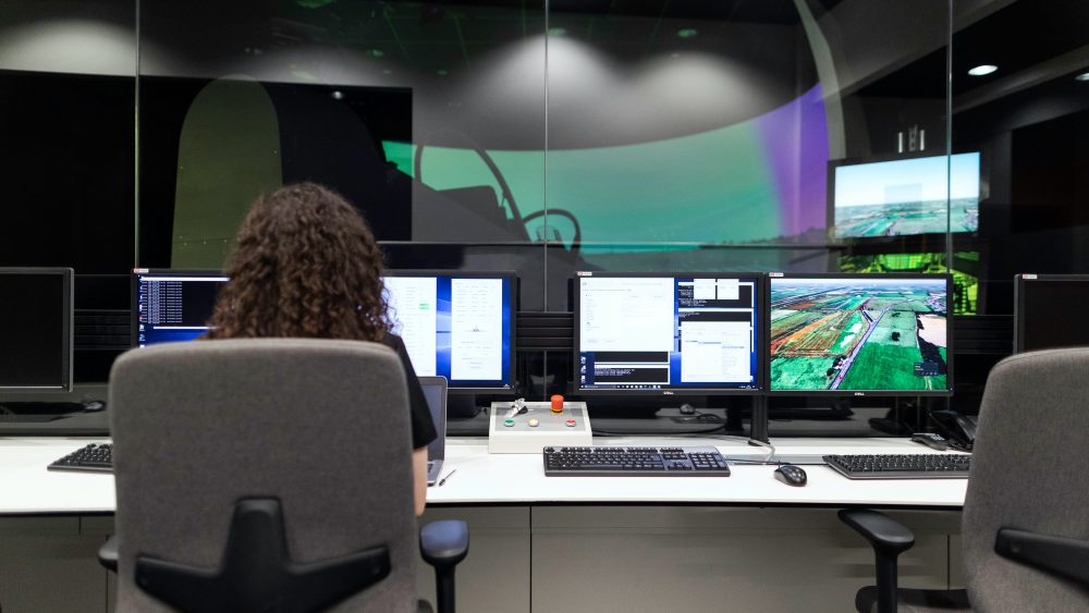 A woman working in front of a computer desk.